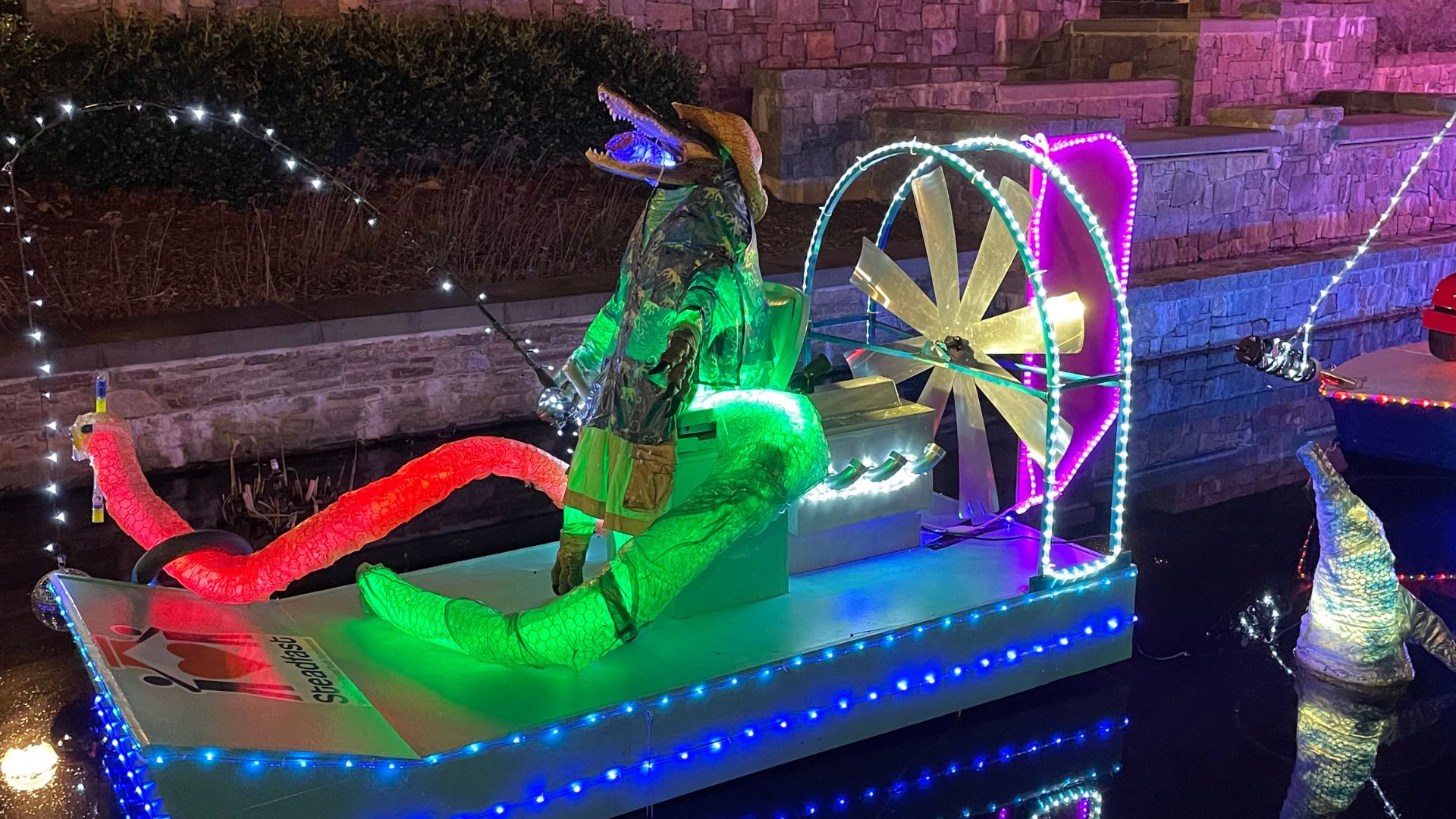 nighttime shot of Steadfast's lighted float during the Sailing Through The Winter Solstice parade of boats on Carroll Creek