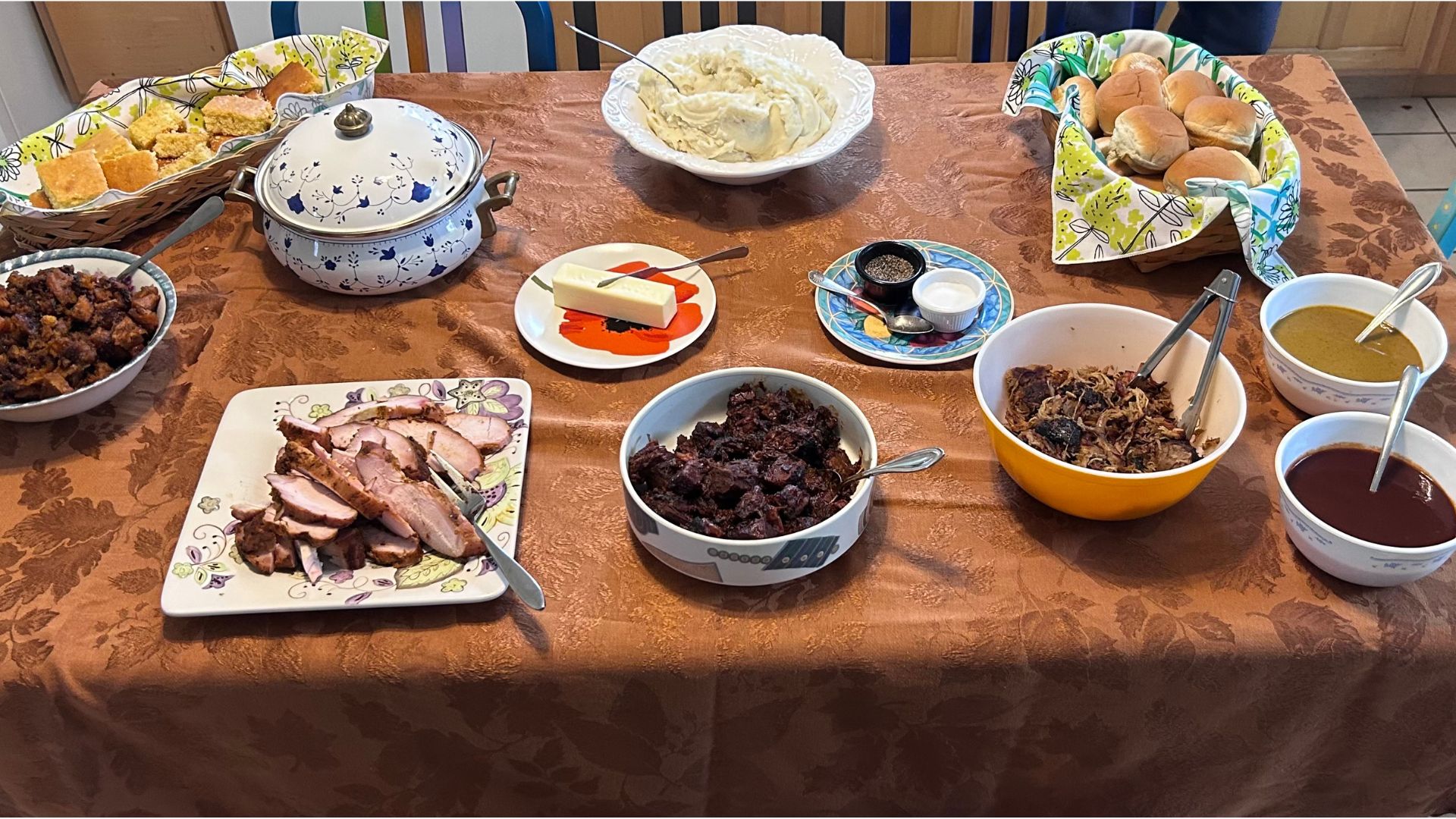 a holiday buffet set out on a brown tablecloth in the Steadfast kitchen