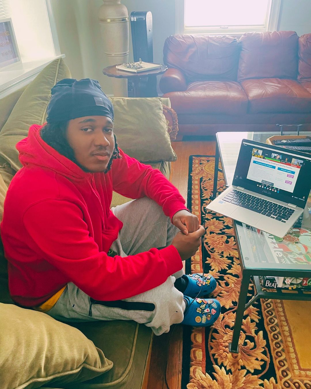young man on a sofa with a laptop in the Steadfast living room