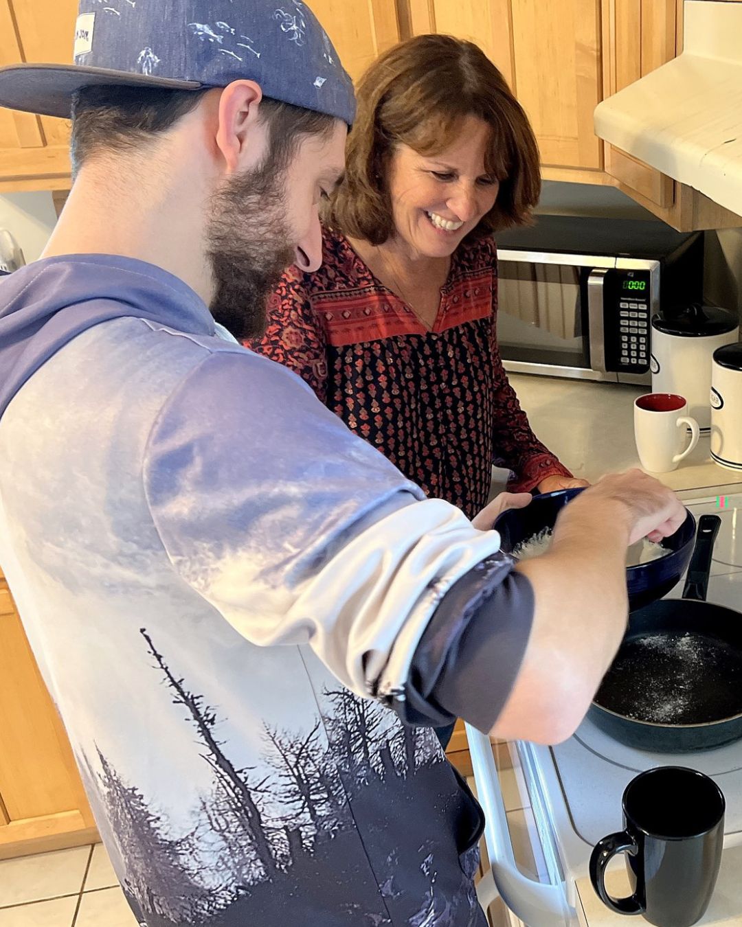 a male and female in Steadfast kitchen cooking